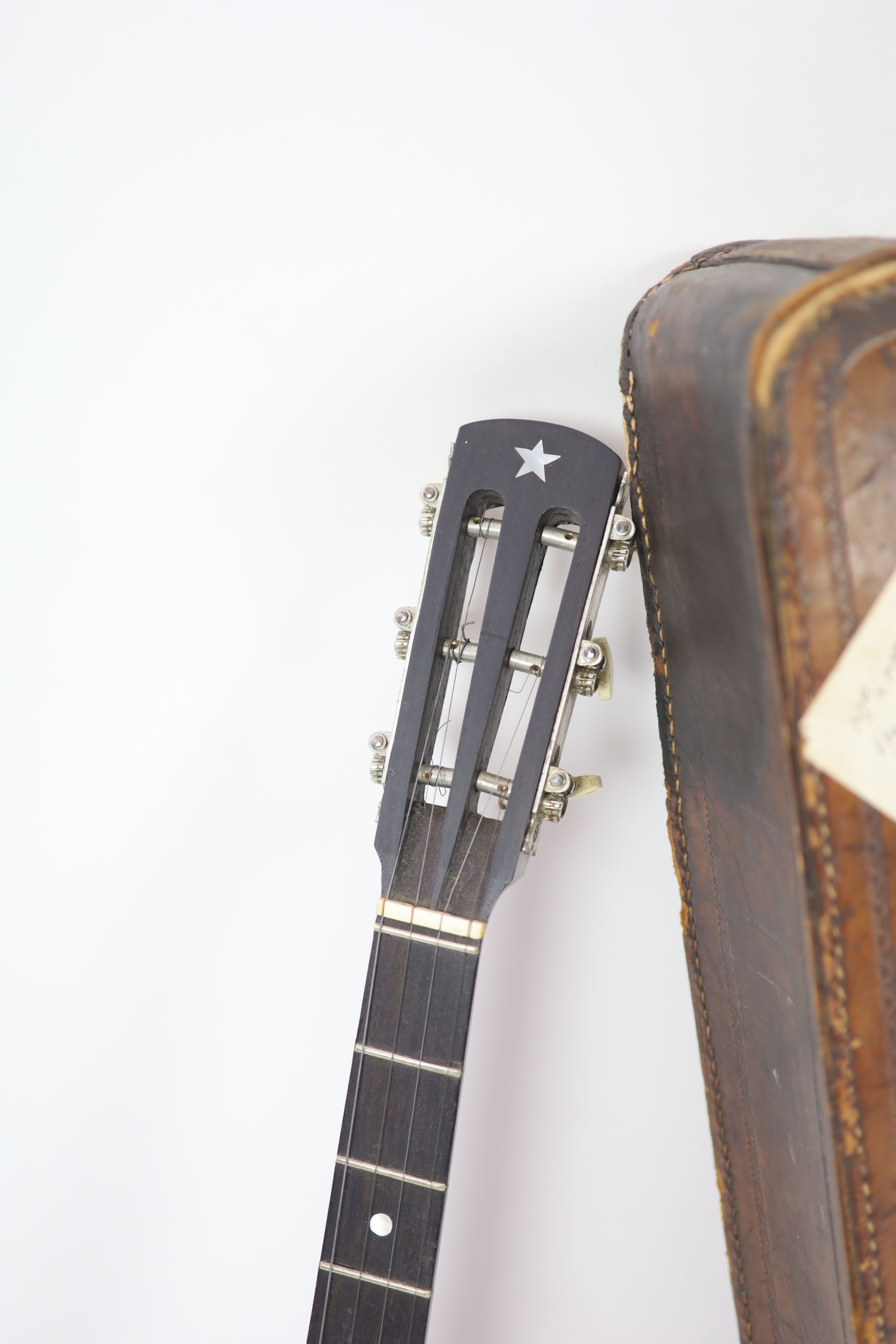 A Clifford Essex ebony mounted banjo, length 94cm, with distressed leather case